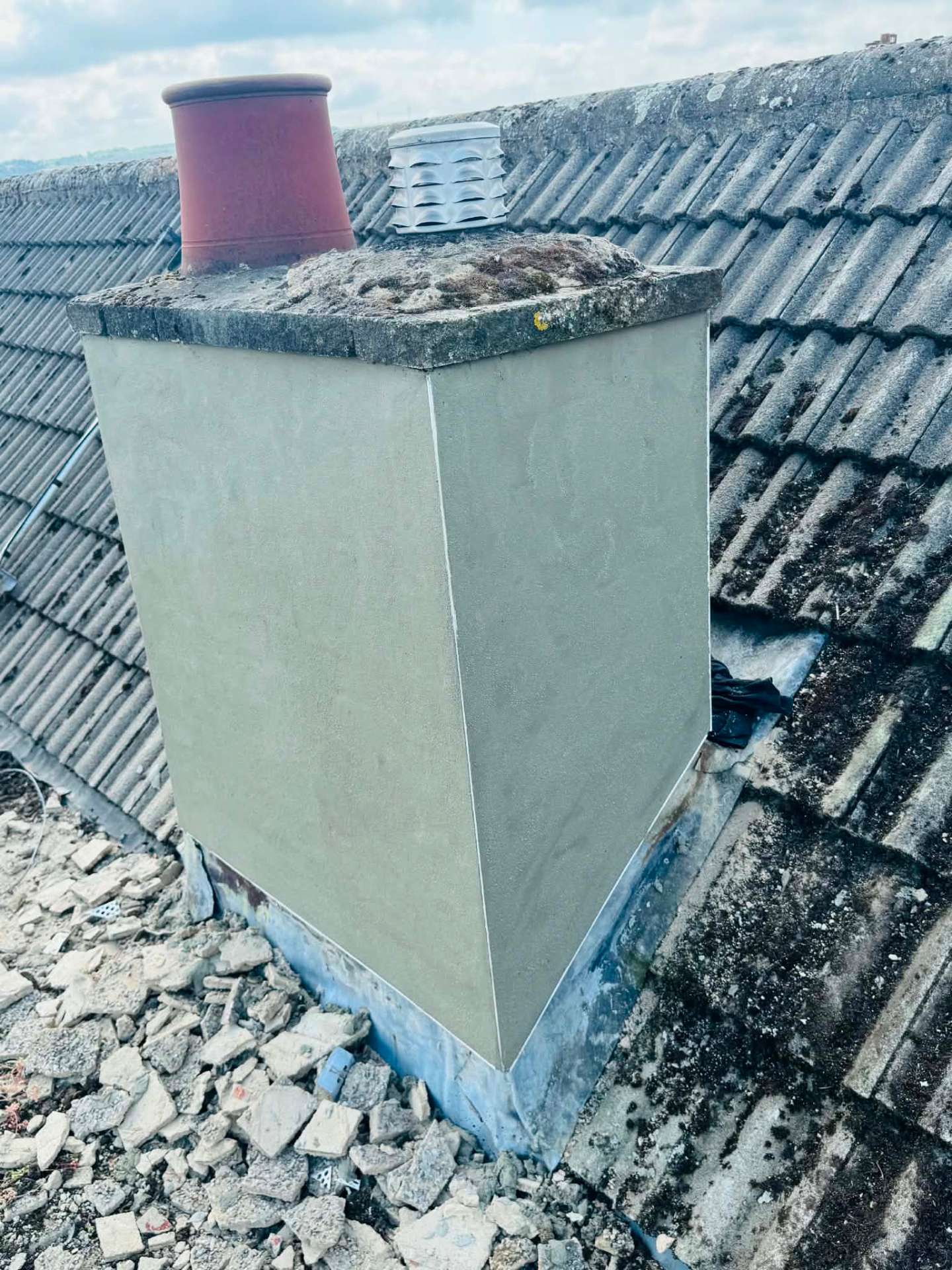 The same chimney stack after being rendered smooth with new lead flashing fitted