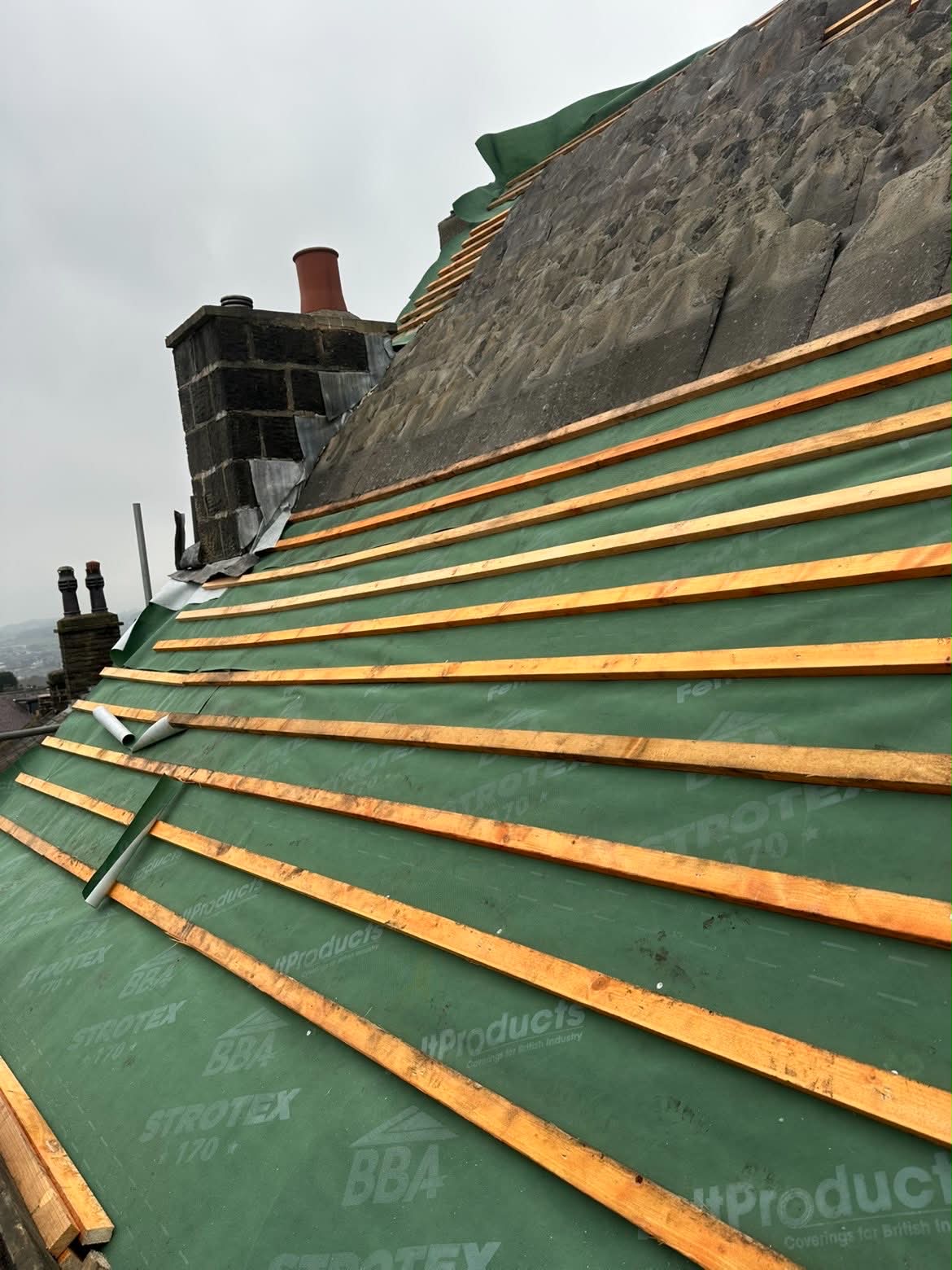 New breathable roofing membrane and treated battens fitted across a stripped roof slope