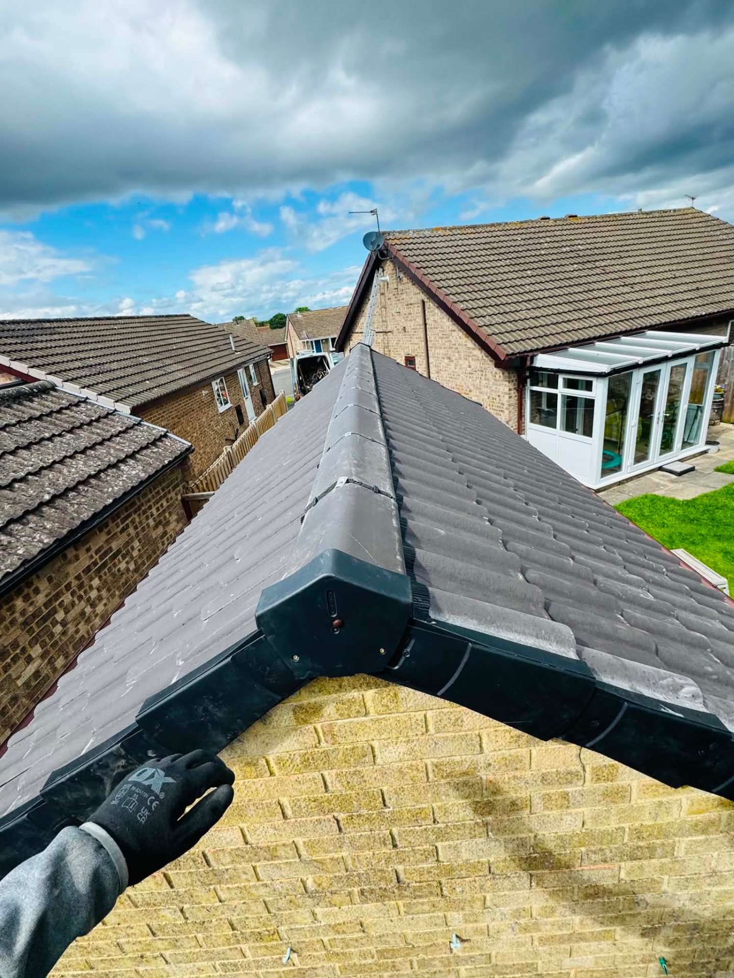 Finished bungalow re-roof with new grey tiles, ridge and dry verge system