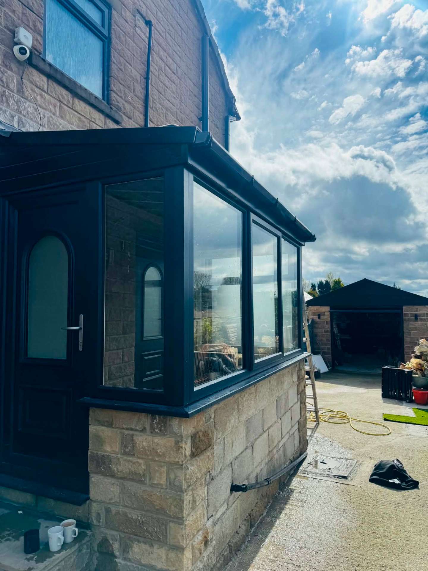 Side view of the completed stone porch with anthracite grey glazing and door