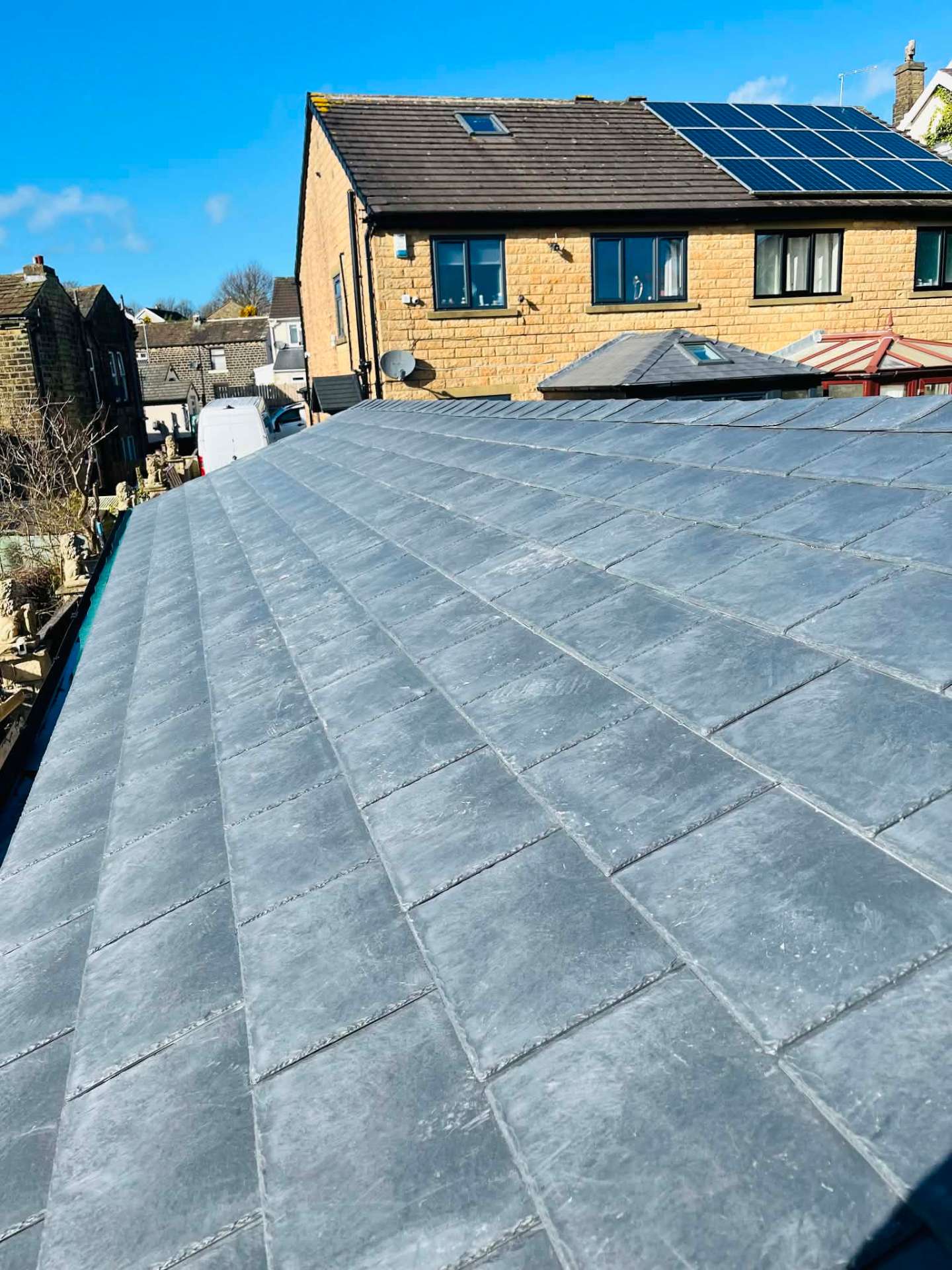 Finished Tapco slate-effect warm roof laid in neat courses on a Yorkshire stone property