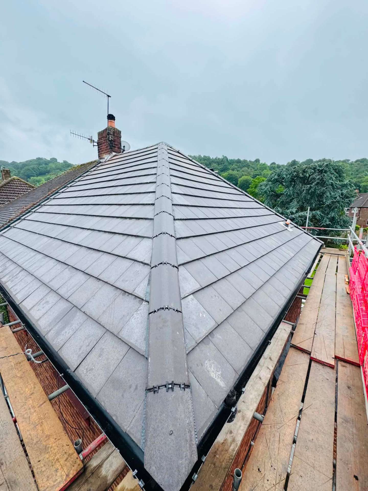 Completed full re-roof by D&M Roofing with new grey tiles and dry-fixed ridge