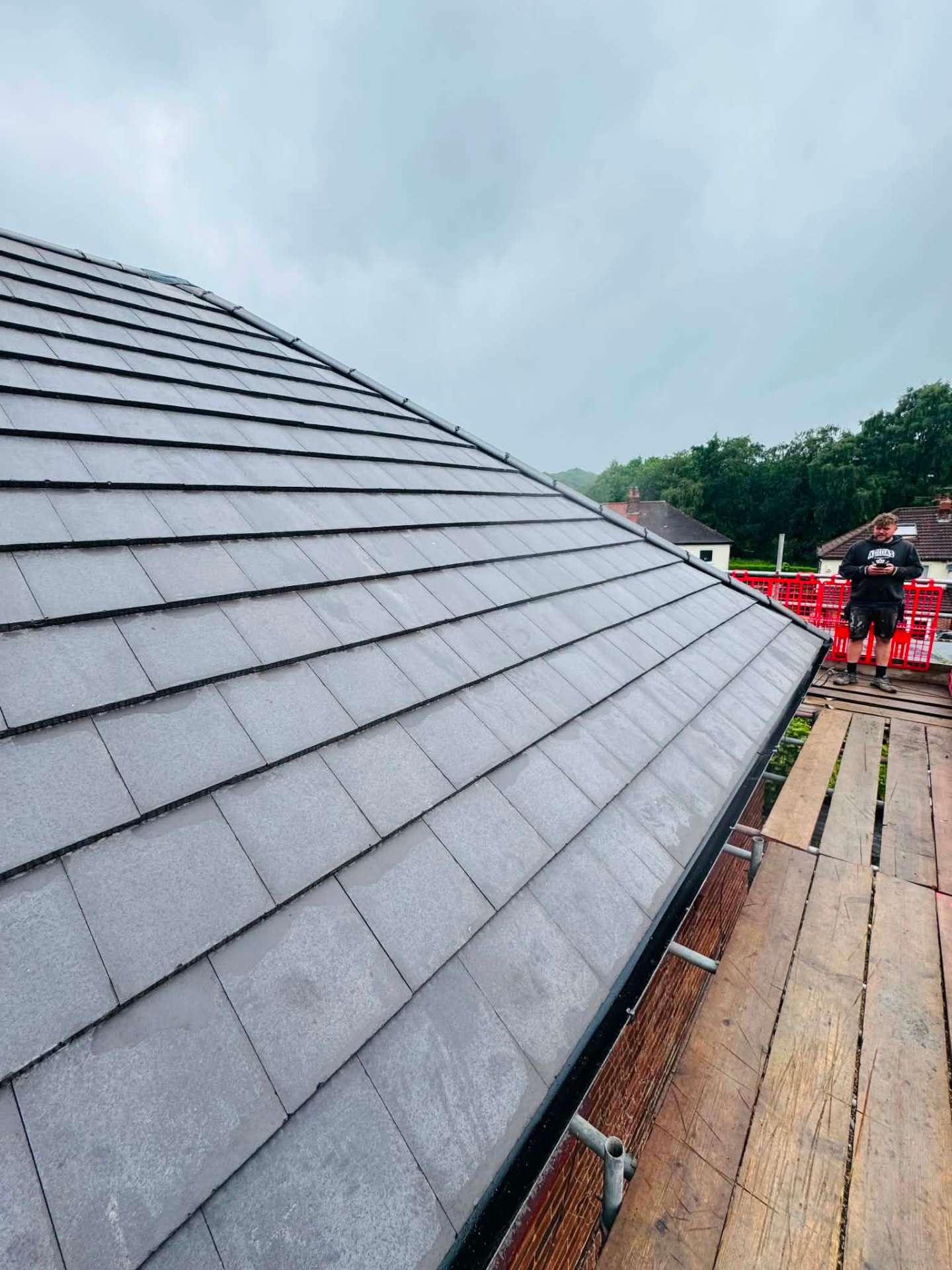 Newly tiled hip and ridge on a completed re-roof, viewed from the scaffold