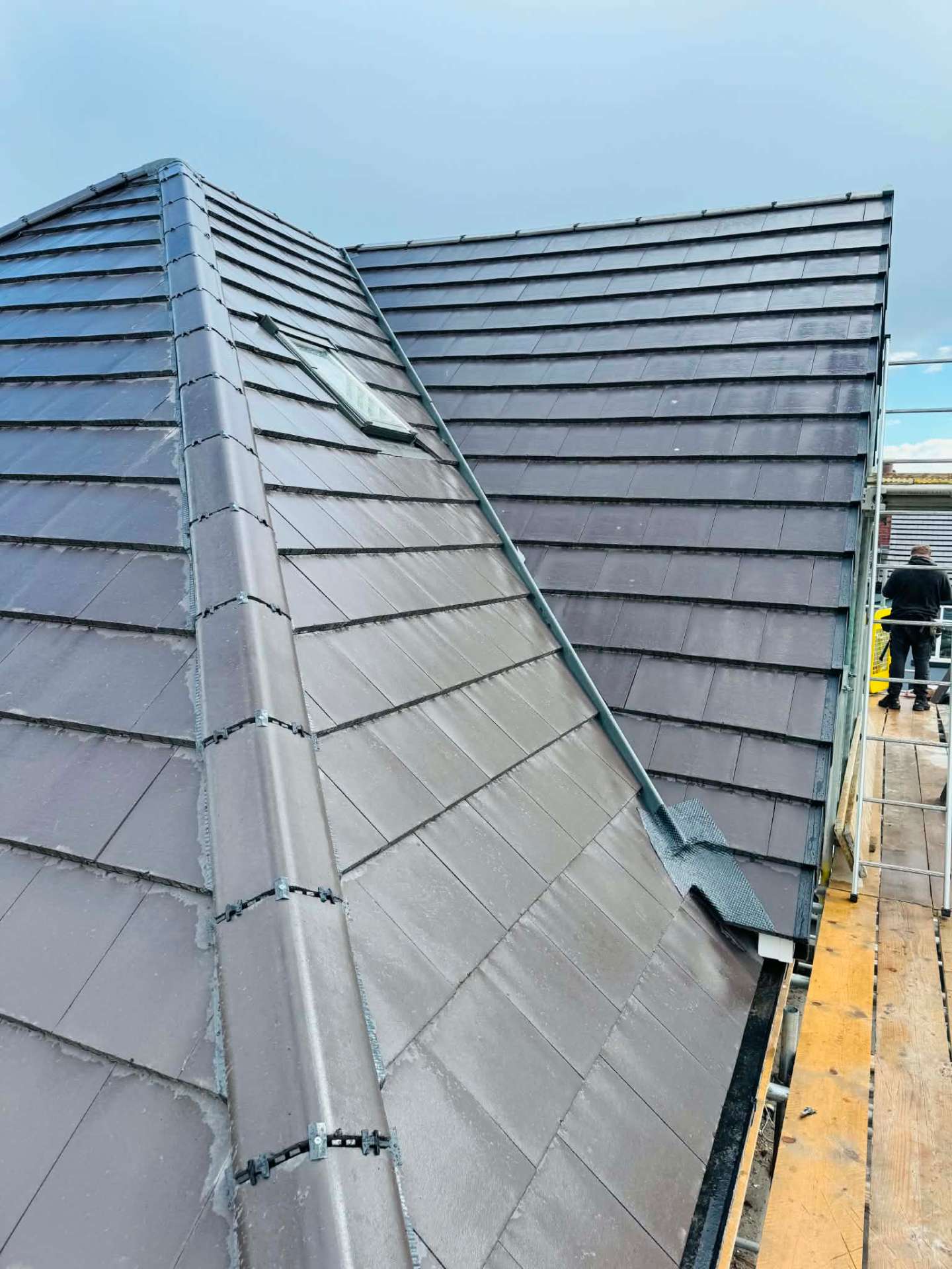 Completed re-roof with a new roof window and neatly finished hips and valley