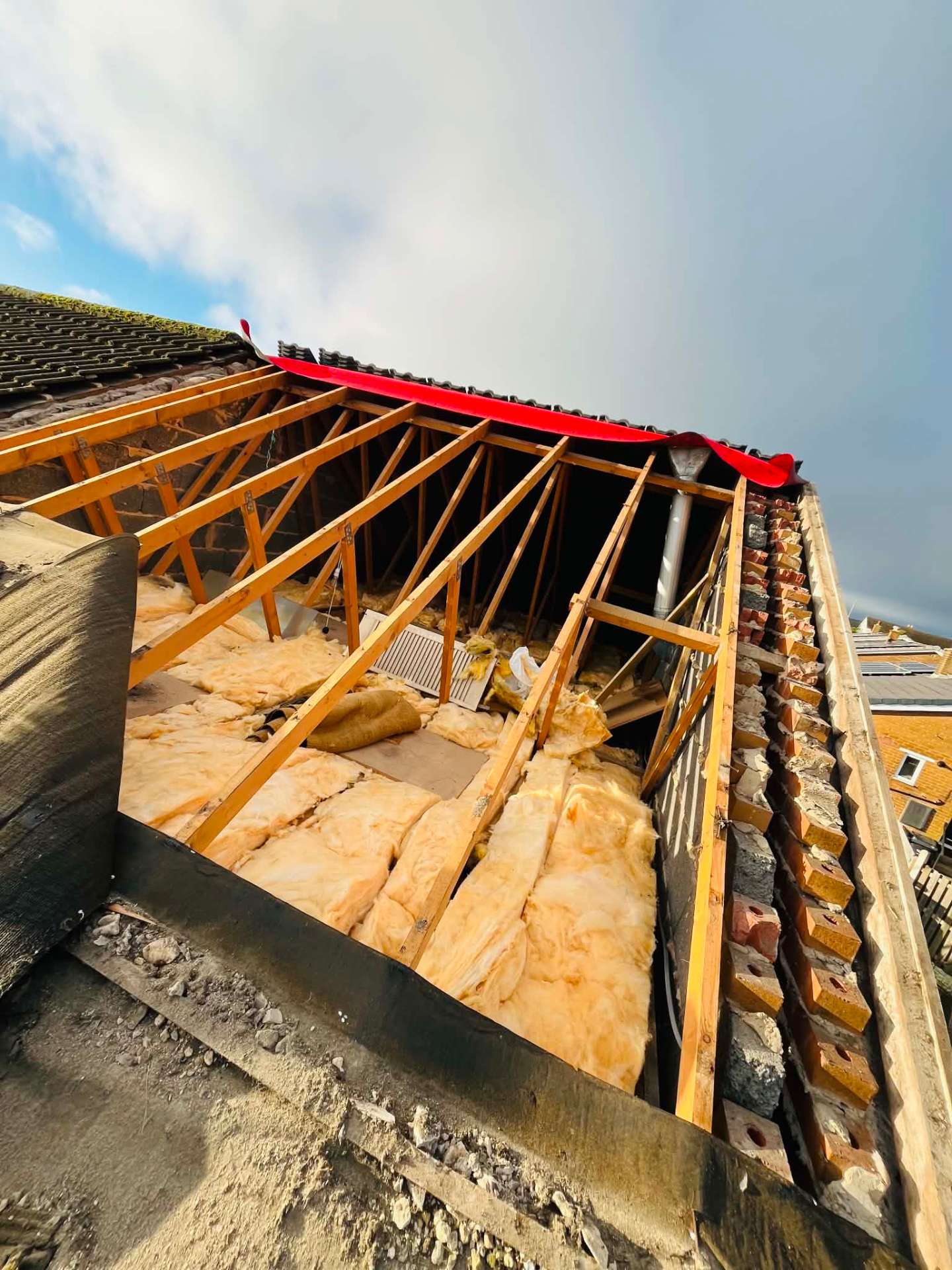 Roof stripped back to the trusses during a full re-roof, ready for new membrane and battens
